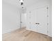 Neutral bedroom offers a ceiling fan, light hardwood floors, and a closet at 1387 Mineral Springs Rd, Hoschton, GA 30548