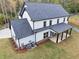 Rear view showcasing a well-manicured lawn and a covered patio, perfect for outdoor enjoyment at 1387 Mineral Springs Rd, Hoschton, GA 30548