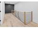 Hallway features hardwood floors, modern railing, and custom wall paneling at 1387 Mineral Springs Rd, Hoschton, GA 30548