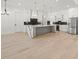 Bright, open kitchen featuring a large island with marble countertop at 1387 Mineral Springs Rd, Hoschton, GA 30548