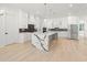 Modern kitchen with marble island, stainless appliances, and plenty of cabinet space at 1387 Mineral Springs Rd, Hoschton, GA 30548