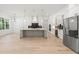 Bright kitchen with large island, stainless steel appliances, and custom cabinetry at 1387 Mineral Springs Rd, Hoschton, GA 30548