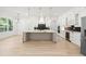 Spacious open kitchen with large island and stainless steel refrigerator at 1387 Mineral Springs Rd, Hoschton, GA 30548