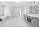 This modern bathroom features dual vanities, a soaking tub, and a marble shower at 1387 Mineral Springs Rd, Hoschton, GA 30548