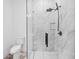 This stylish shower has marble surround, rainfall shower head, and glass doors at 1387 Mineral Springs Rd, Hoschton, GA 30548