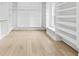 This walk-in closet features custom shelving, ample storage, and natural light at 1387 Mineral Springs Rd, Hoschton, GA 30548