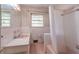 Bathroom featuring pink tile, a bathtub with a shower curtain, and a vintage-style vanity at 5655 Campbellton Sw Rd, Atlanta, GA 30331
