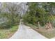 Long driveway leading up to the property, surrounded by lush greenery and mature trees at 5655 Campbellton Sw Rd, Atlanta, GA 30331