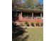 Exterior view of a brick home with a covered front porch and well-manicured landscaping in the front yard at 5655 Campbellton Sw Rd, Atlanta, GA 30331