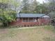 Charming brick home with a cozy front porch and a well-maintained landscaped yard at 5655 Campbellton Sw Rd, Atlanta, GA 30331