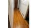 Long hallway featuring hardwood floors and neutral-colored walls, leading to other rooms in the house at 5655 Campbellton Sw Rd, Atlanta, GA 30331