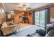Living room with wood paneling, a ceiling fan, sliding glass doors, and comfortable seating at 5655 Campbellton Sw Rd, Atlanta, GA 30331