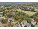 An aerial view shows the neighborhood with established trees in the fall at 3047 Players Dr, Jonesboro, GA 30236