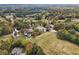 Gorgeous aerial view of a golf course with clubhouse, water features, and lush trees during the day at 3047 Players Dr, Jonesboro, GA 30236