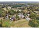 Aerial view featuring the community center, golf course, pond and surrounding mature trees at 3047 Players Dr, Jonesboro, GA 30236
