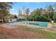 Outdoor pool closed for the season with surrounding trees and a structure in the background at 3047 Players Dr, Jonesboro, GA 30236