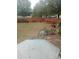 An angle view of the backyard and the wooden fence with a table and a few chairs at 102 Ozark Trl, Canton, GA 30114