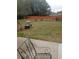 A backyard with various furniture and a wooden fence and green grass at 102 Ozark Trl, Canton, GA 30114
