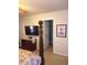 View of the carpeted bedroom with a television and doorway to the bathroom at 102 Ozark Trl, Canton, GA 30114