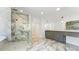 Elegant bathroom with a glass-enclosed shower, marble flooring, and a vanity with dual sinks at 3785 Lower Roswell Rd, Marietta, GA 30068