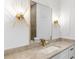 Stylish bathroom with gold sconces, hardware, and waterfall faucet on neutral countertop at 3785 Lower Roswell Rd, Marietta, GA 30068