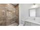 Modern bathroom features a glass enclosed shower with marble tile and a sleek vanity with a rectangular mirror at 3785 Lower Roswell Rd, Marietta, GA 30068
