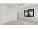 A bedroom with a large window bringing in natural light, hardwood floors and white walls at 3785 Lower Roswell Rd, Marietta, GA 30068