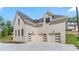 Elegant exterior elevation with a three-car garage and a light brick facade at 3785 Lower Roswell Rd, Marietta, GA 30068