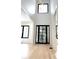 Bright foyer with a soaring ceiling, black-framed windows, and sleek modern finishes at 3785 Lower Roswell Rd, Marietta, GA 30068