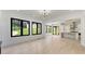 Spacious living room featuring hardwood floors, large windows, and an open layout to the kitchen at 3785 Lower Roswell Rd, Marietta, GA 30068