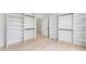 Bright walk-in closet with built-in shelving, hanging racks, and hardwood floors at 3785 Lower Roswell Rd, Marietta, GA 30068