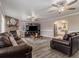 Inviting living room with a stone fireplace, hardwood floors, and neutral wall tones at 1871 Weems E Rd, Locust Grove, GA 30248