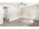 A spacious bedroom featuring plush carpeting, a ceiling fan, and ensuite bathroom at 1185 Oak Villas Nw Ct, Conyers, GA 30012