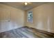 Bedroom with window, wood-look floors, and ceiling fan at 773 Harwell Nw Rd, Atlanta, GA 30318
