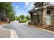 Community entrance with stone gatehouse featuring signage and neatly manicured landscaping at 738 Stickley Oak Way, Woodstock, GA 30189