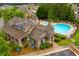 Aerial view of community pool and clubhouse surrounded by lush landscaping and trees at 738 Stickley Oak Way, Woodstock, GA 30189