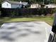 Backyard showcasing a concrete patio and fence enclosing the lawn and shrubs at 1267 Lucan Nw Ln # Wc217, Lawrenceville, GA 30043