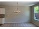 Bright dining area with a modern chandelier and plush carpeting, perfect for Gathering meals and entertaining at 1267 Lucan Nw Ln # Wc217, Lawrenceville, GA 30043