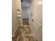 Hallway with tiled floors and neutral walls, leading to various rooms in the home at 1267 Lucan Nw Ln # Wc217, Lawrenceville, GA 30043
