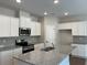 The kitchen features stainless steel appliances, granite countertops, white cabinets, and recessed lighting at 1267 Lucan Nw Ln # Wc217, Lawrenceville, GA 30043