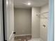 Laundry room featuring a white wall, tile flooring, and shelving unit with an outlet box at 1267 Lucan Nw Ln # Wc217, Lawrenceville, GA 30043