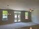 Open concept living area with large windows, glass doors, and modern light fixtures for a bright and airy feel at 1267 Lucan Nw Ln # Wc217, Lawrenceville, GA 30043