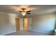 Spacious main bedroom featuring a ceiling fan, neutral paint and plush carpeted flooring at 1267 Lucan Nw Ln # Wc217, Lawrenceville, GA 30043