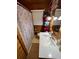 Bathroom features wood paneling, white vanity, and shower with decorative curtain at 745 Shiloh Nw Rd, Kennesaw, GA 30144