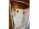 Cozy bathtub with wood walls and white shower-tub surround, plus updated shower head at 745 Shiloh Nw Rd, Kennesaw, GA 30144