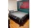 Bedroom features natural hardwood floors, a cozy bed, and a flag at 745 Shiloh Nw Rd, Kennesaw, GA 30144