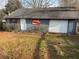 View of the exterior of the detached garage with Coca Cola sign, door, window and foliage at 745 Shiloh Nw Rd, Kennesaw, GA 30144