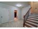 Basement staircase with neutral tile flooring, wood steps and access to another room at 4140 Onslow Se Pl, Smyrna, GA 30080