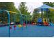 Community playground with swings, a playset featuring a small slide, and a covered play area at 4140 Onslow Se Pl, Smyrna, GA 30080