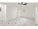 Large bedroom with marble-style floors, ceiling fan, and multiple doors at 641 Hamilton E Holmes Nw Dr, Atlanta, GA 30318